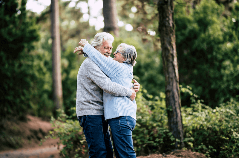 Couple in a forest talking about their ethical pension fund