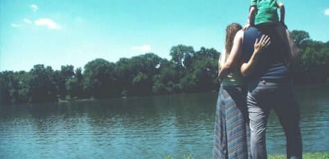 Family talking about finances next to a lake