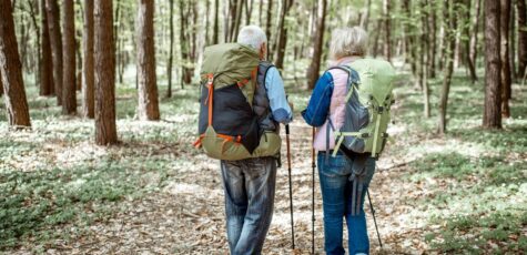 Elderly couple walking talking about How To Calculate The Right Amount To Withdraw From Your Pension