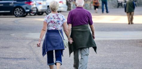 Man and woman walking side by side talking about how much you should drawdown from your pension