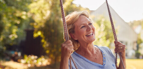 A woman on a swing pondering on what a pension drawdown means.